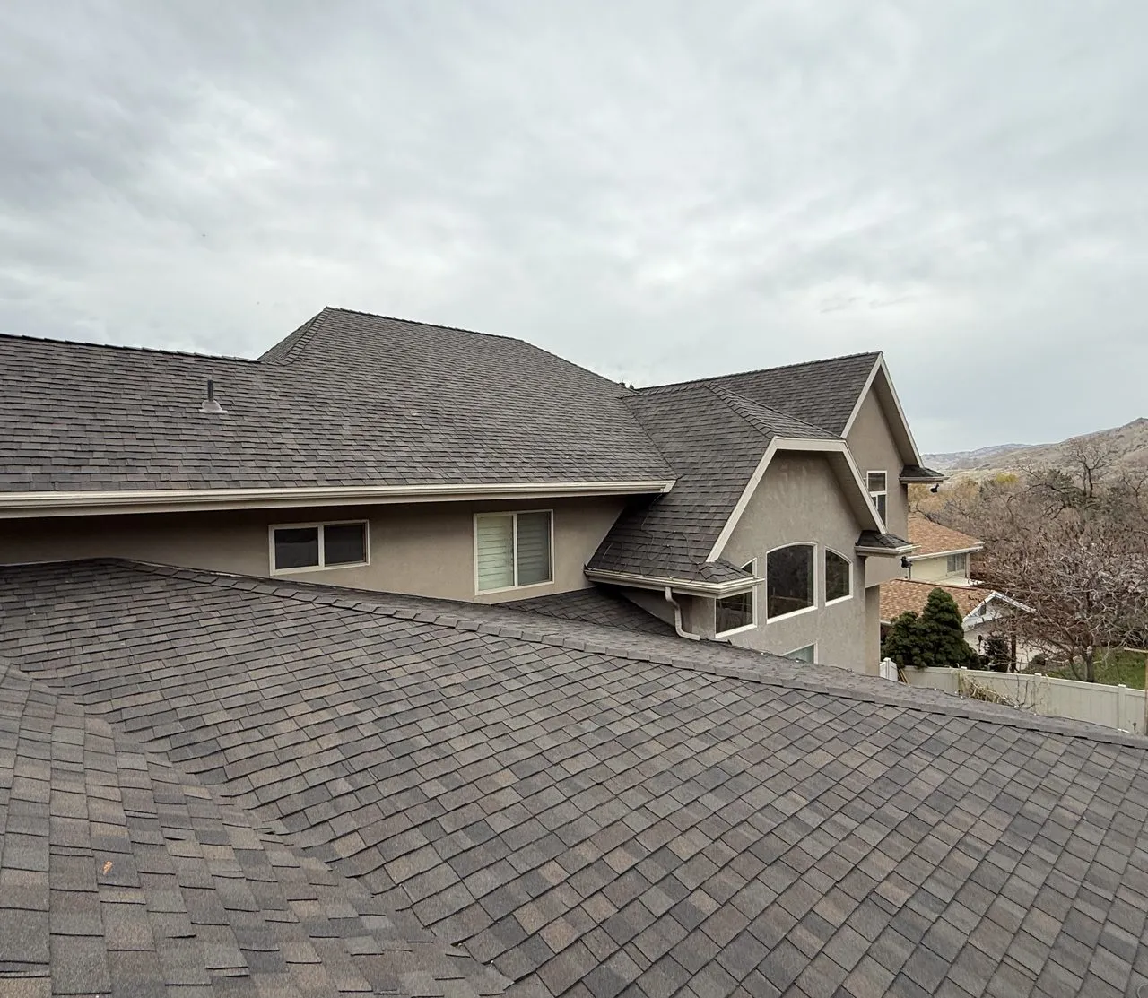 Ogden roof with wind damage - torn shingles and exposed underlayment repaired by Frame Restoration Utah crew
