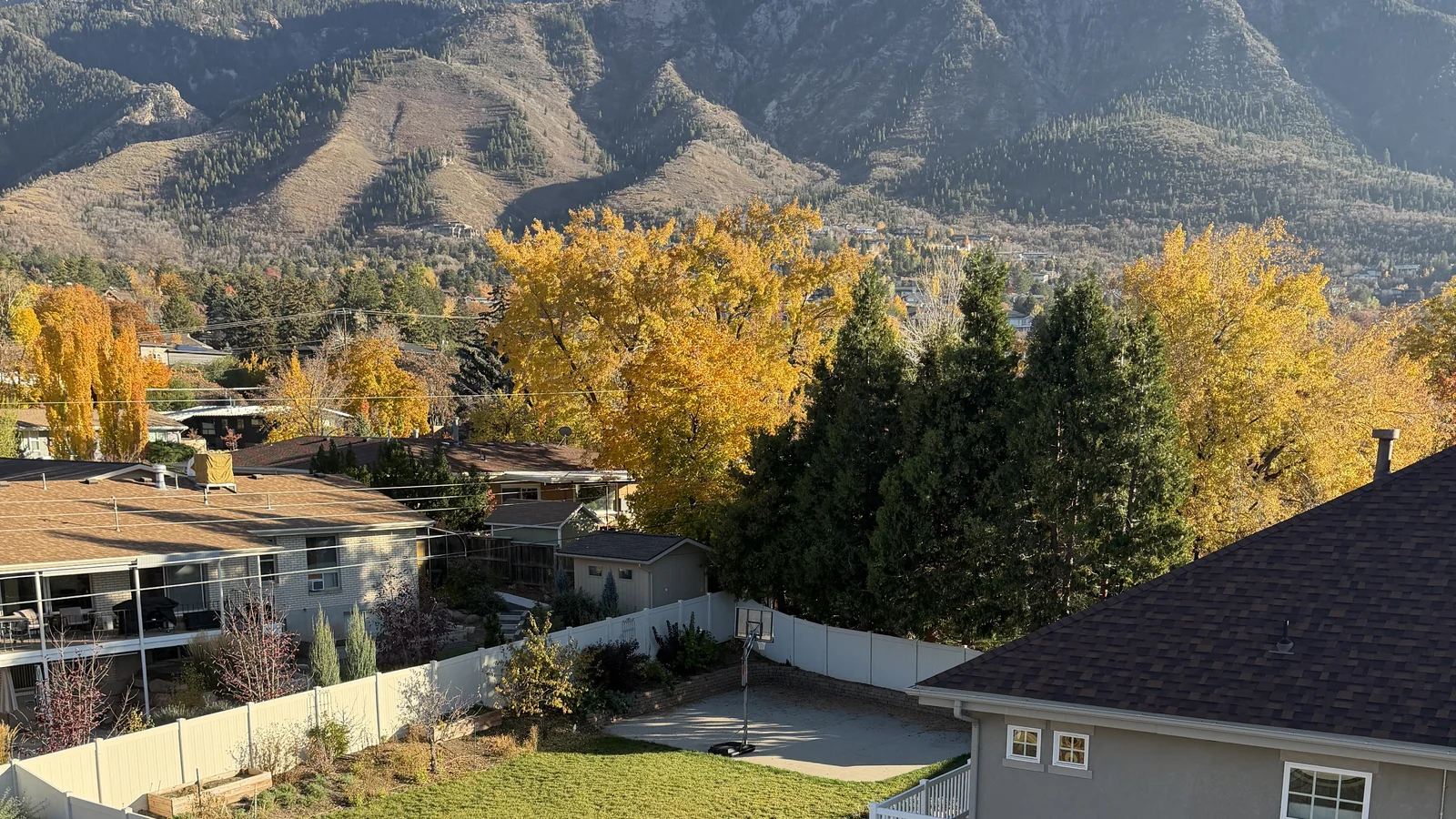 Mt. Olympus and Salt Lake Valley east-bench premium home reroof by Frame Restoration Utah — autumn canopy, established neighborhood